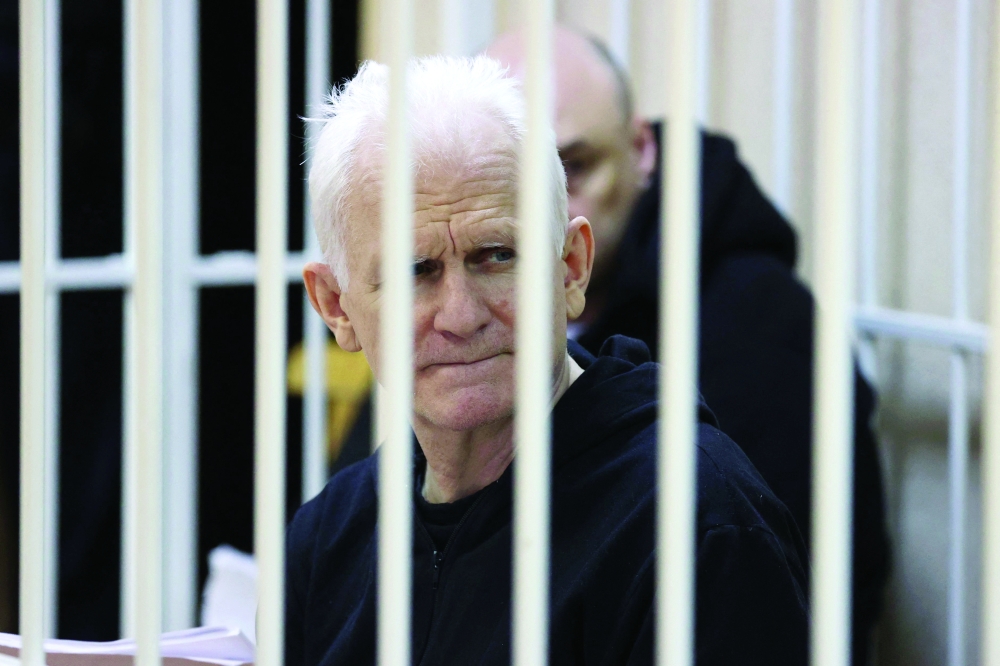 Nobel Prize winner Ales Bialiatski is seen in the defendants' cage in the courtroom at the start of the hearing in Minsk on Thursday. — AFP
