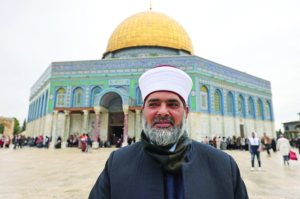 Palestinian Sheikh Omar al Kiswani, director of Al Aqsa Mosque, poses in front of the Dome of the Rock at the Al Aqsa Mosque compound in the Old City of Jerusalem. - AFP
