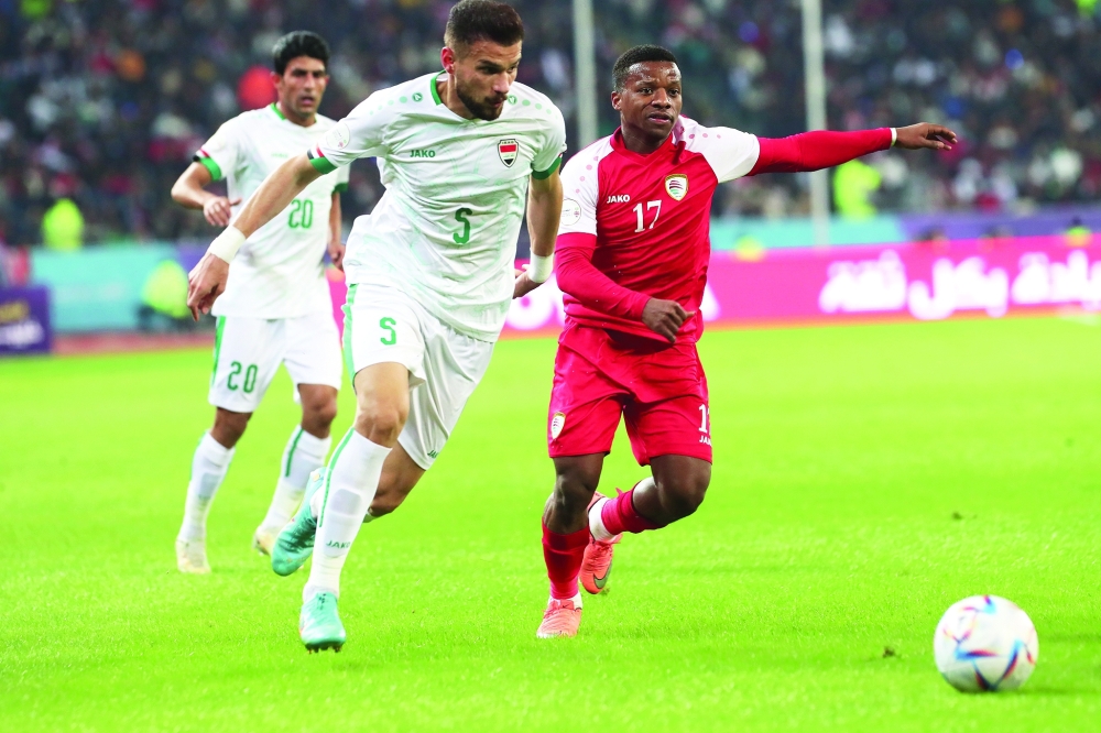 Oman and Iraq players fight for the ball. -- Abdulwahid al Hamadani