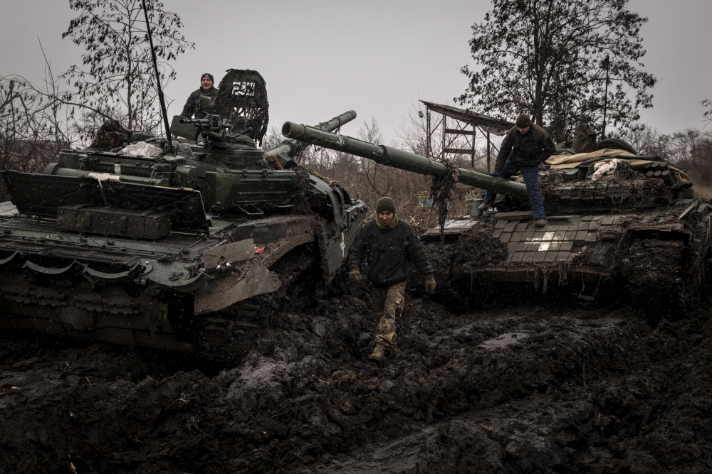Ukrainian service members work to salvage equipment and parts from a broken T-72 tank in the Donetsk region of Ukraine.