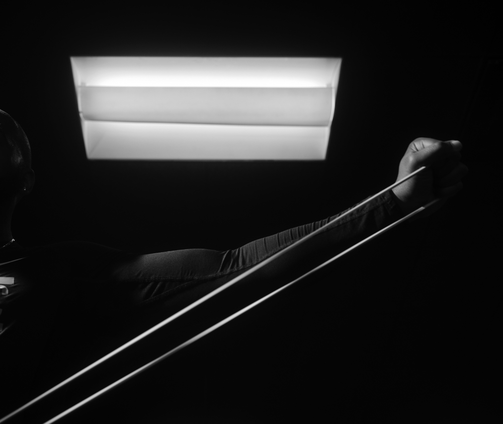 Gerard Burley, a fitness coach, uses exercise bands to stretch his shoulder, in Washington, D.C., March 30, 2022. (Jared Soares/The New York Times)