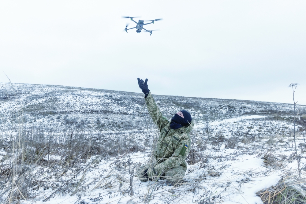 A member of a volunteer battalion practices the launch and retrieval of a DJI Mavic drone as the group trains outside Kyiv.
