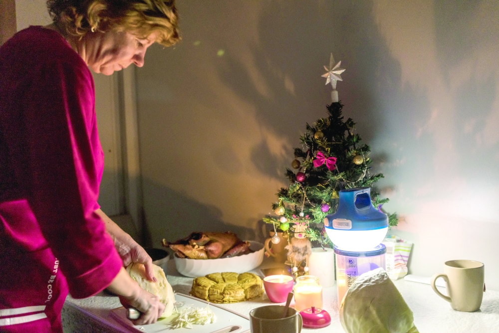 Oksana Kovtun prepares an Orthodox Christmas Eve meal after the power went out in the family’s temporary home in Makariv, Ukraine. 