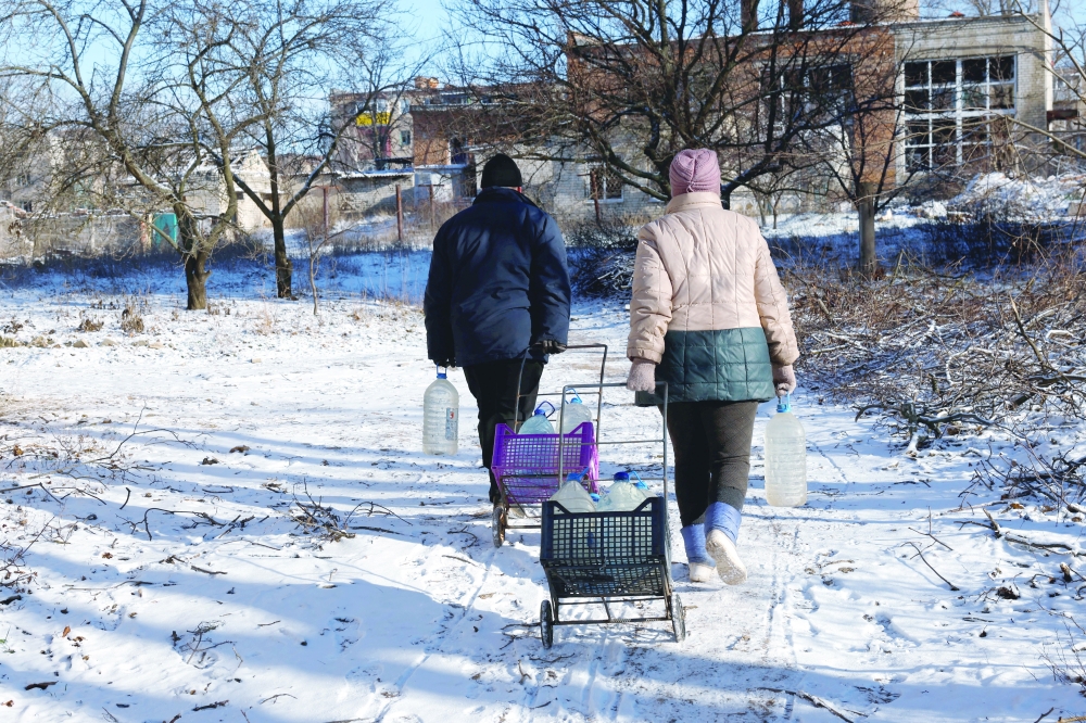 Ukrainians return to their shelters after gathering water, as Russia’s attack on Ukraine continues, in Siversk. -- Reuters