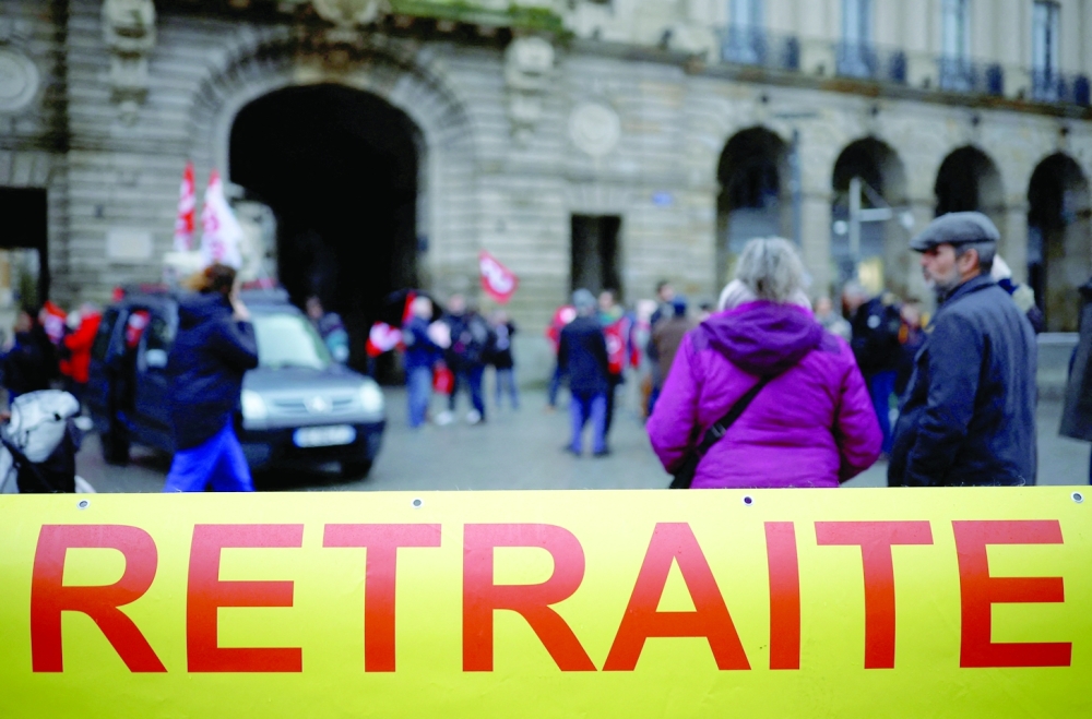 Protestors hold a banner which reads ‘retirement’ during a demonstration against pension reform in Rennes on the day the French government unveils its pension reform. — Reuters