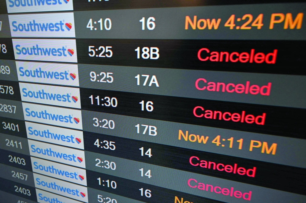 A flight board shows cancelled flights at Los Angeles International Airport. -- AFP