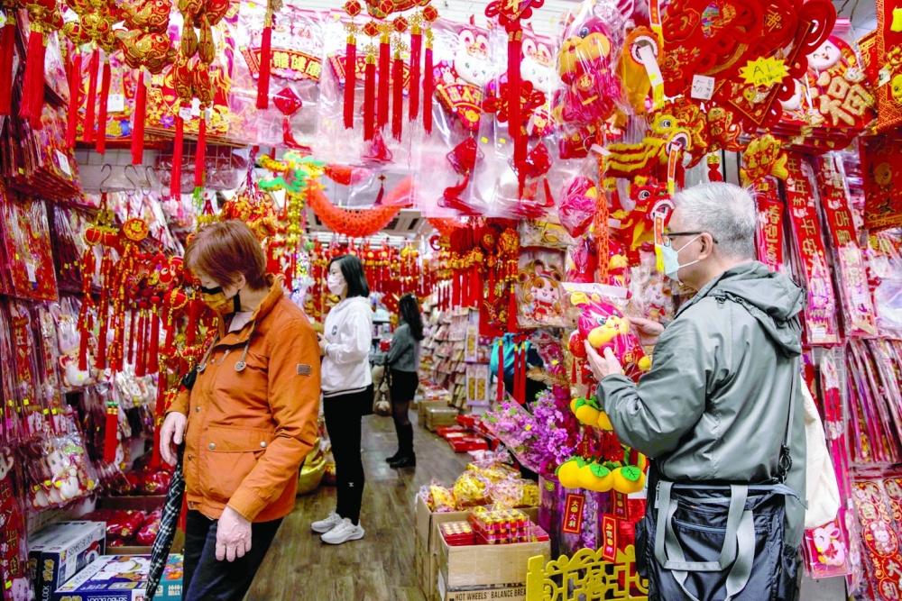 People look at decorations for sale in Hong Kong on January 12, 2023 ahead of the Lunar New Year of the Rabbit, which falls on January 22. — AFP