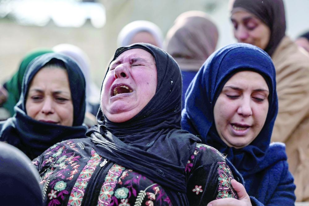 Palestinian relatives mourn the death of Abdulhadi Nazzal, reportedly killed during a raid by Israeli forces in Qabatia town, during his funeral in the same village in occupied West Bank. - AFP 
