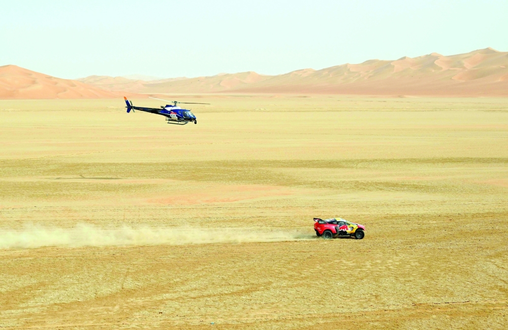 French driver Sebastien Loeb and Belgian co-driver Fabian Lurquin steers his Brx during during Stage 12 of the Dakar 2023 between Empty Quarter Marathon and Saybah, in Saudi Arabia, on January 13, 2023.  (Photo by FRANCK FIFE / AFP)