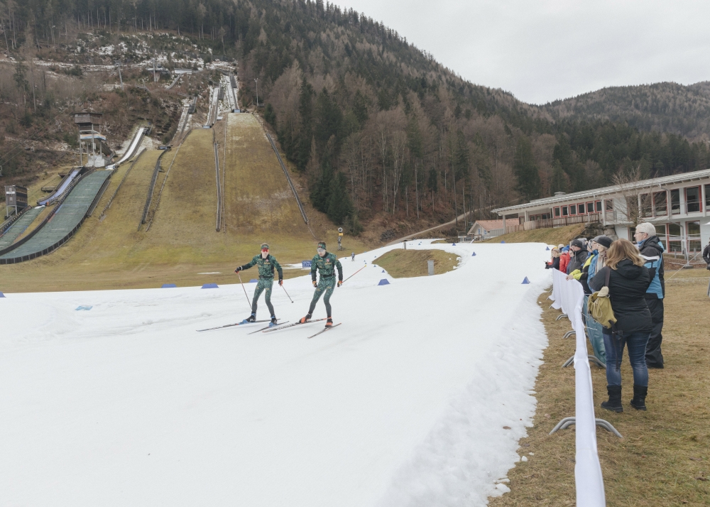 Biathlon athletes train on a track of “farmed snow,” snow stored and packed from the previous winter and covered in reflective tarp, in the Bavarian village of Ruhpolding, Germany, Jan. 12, 2023. (Andrea Mantovani/The New York Times)