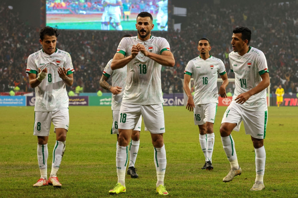 Iraq's midfielder Aymen Hussein (C, #18) celebrates after scoring his team's second goal during the Arabian Gulf Cup semi-final football match between Iraq and Qatar at the Basra International Stadium in Iraq's southern city on January 16, 2023.  (Photo by AHMAD AL-RUBAYE / AFP)

