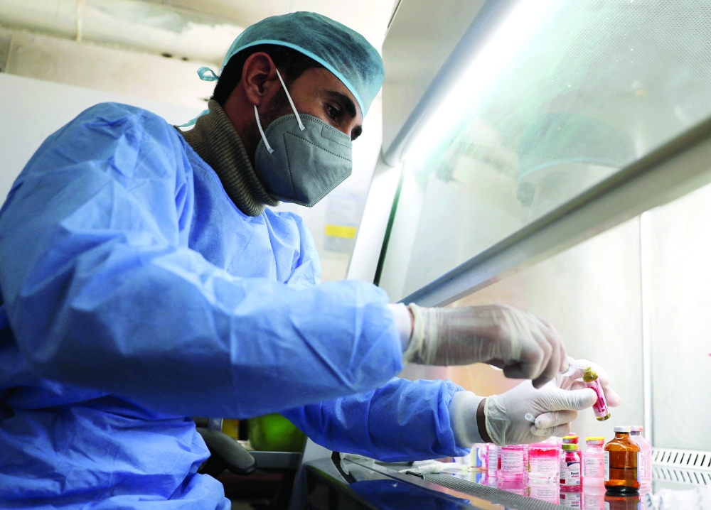 An employee of the National Oncology Center prepares medicines at the centre in Sanaa. - Reuters
