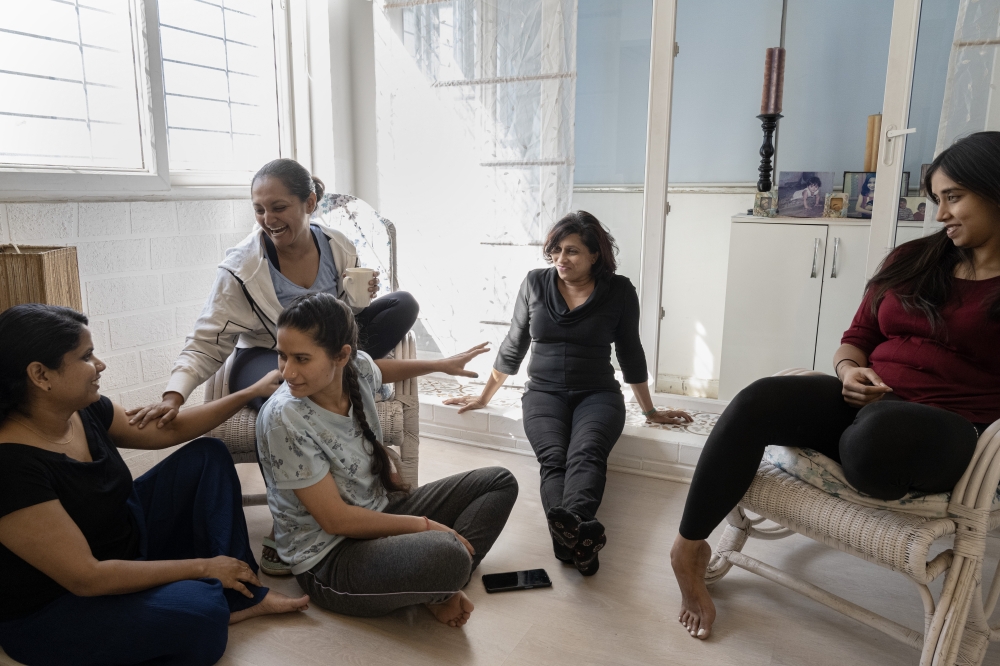 Meera Shankar, center, with the women to whom she rents rooms with no restrictions, in Bengaluru, India, Jan. 14, 2023. (Saumya Khandelwal/The New York Times)