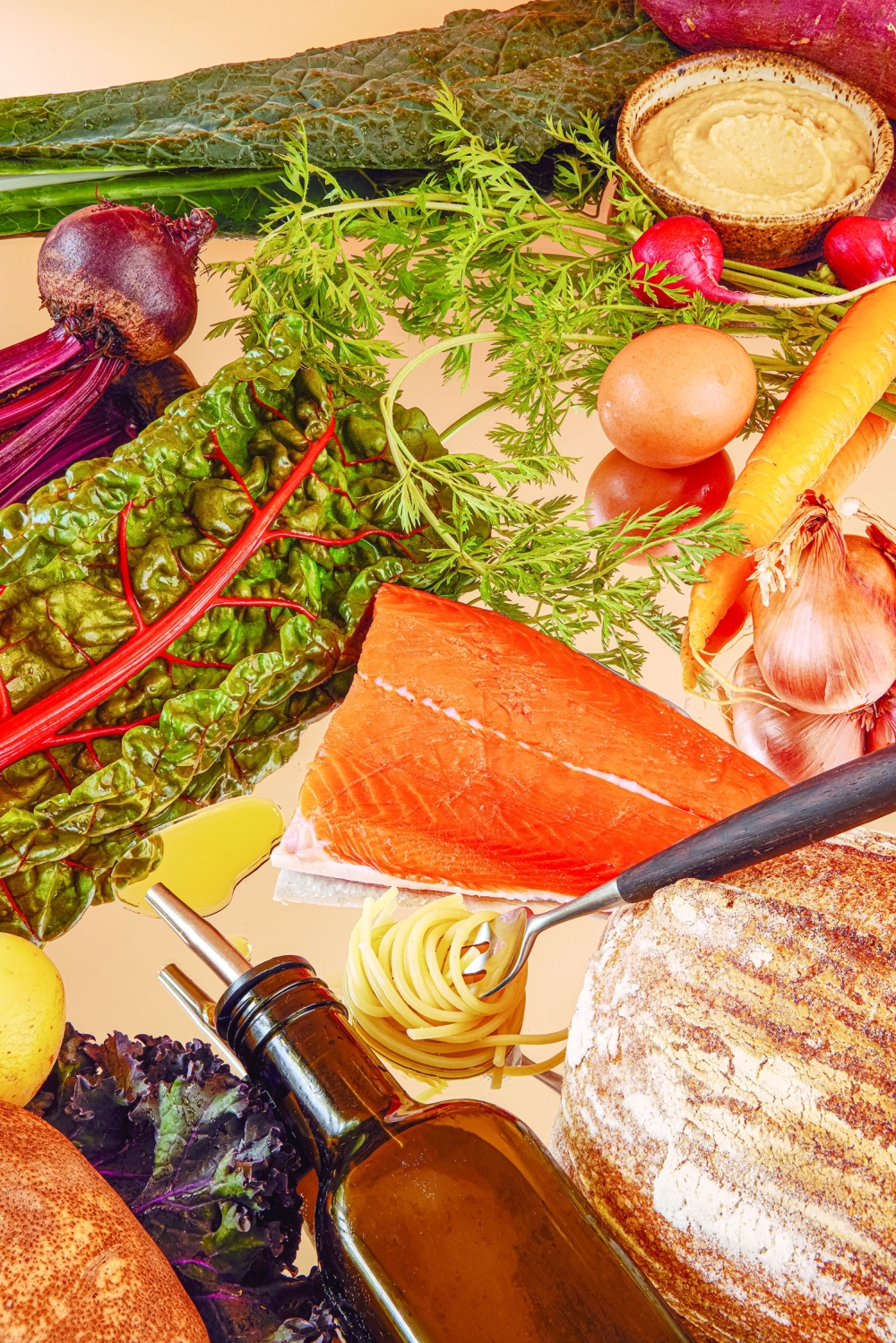 Staples of the Mediterranean diet: grains, root vegetables, olive oil, hummus, leafy greens and lean fish like salmon, in San Francisco, Jan. 5, 2023. (Lauren Segal/The New York Times)