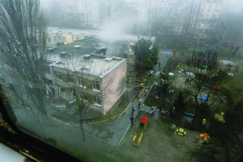 Emergency personnel work at the site of a helicopter crash in Brovary on Wednesday. — Reuters
