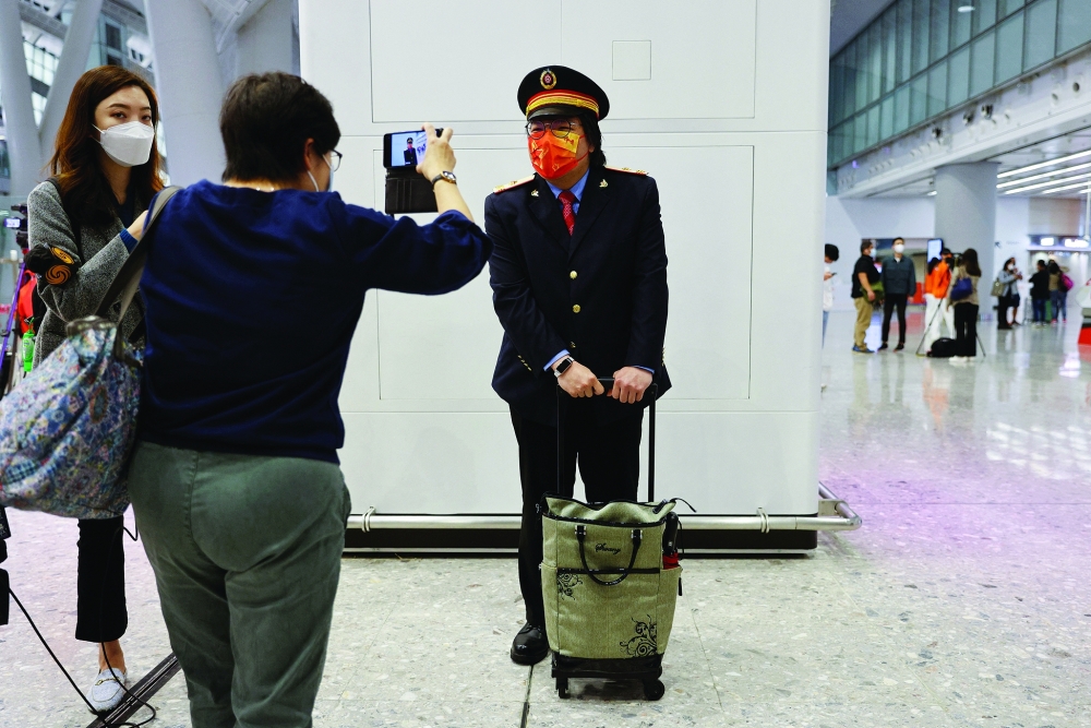 A passenger dressed as train driver poses for a picture in Hong Kong. — Reuters
