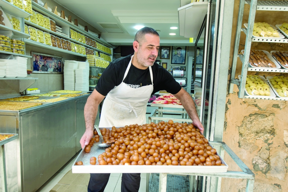 A tray of awameh, or fried dough balls soaked in sugar syrup, at Al Aseel Sweets on Al-Wad Street in the Old City of Jerusalem, Oct. 12, 2022. (Tzachi Ostrovsky/The New York Times)