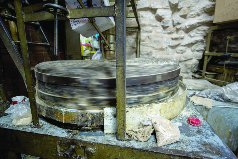 Al Jebrini Tahini, one of the oldest tahini mills in the Old City of Jerusalem, which uses a basalt stone to mill sesame seeds, Oct. 12, 2022. (Tzachi Ostrovsky/The New York Times)