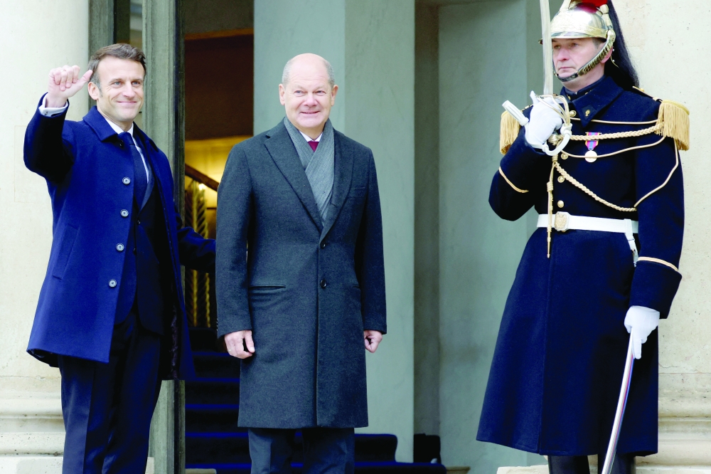 France's President Emmanuel Macron with German Chancellor Olaf Scholz as they arrive to attend a cabinet meeting as part of the celebration of the 60th anniversary of the signing of the Elysee Treaty in Paris, France, on Sunday. -- Reuters