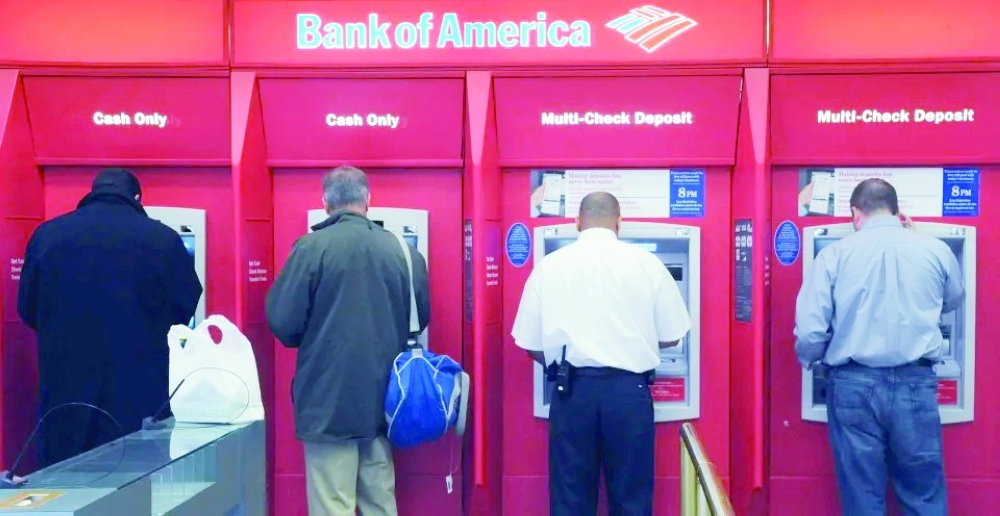 Customers use ATMs at a Bank of America branch office. — Reutes