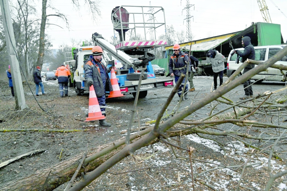 Workers repair power lines following a Russian missile strike on the industrial zone of Kyiv amid Russian war of Ukraine. - AFP