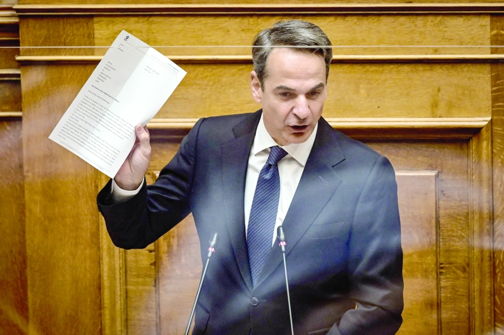 Greek Prime Minister Kyriakos Mitsotakis delivers a speech during a parliamentary debate on a vote of no confidence against the government in Athens. - AFP