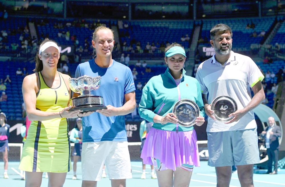 Tennis - Australian Open - Melbourne Park, Melbourne, Australia - January 27, 2023 Mixed doubles final winners Brazil's Luisa Stefani and Rafael Matos and runners up India's Rohan Bopanna and Sania Mirza pose with the trophies after the match REUTERS/Jaimi Joy
