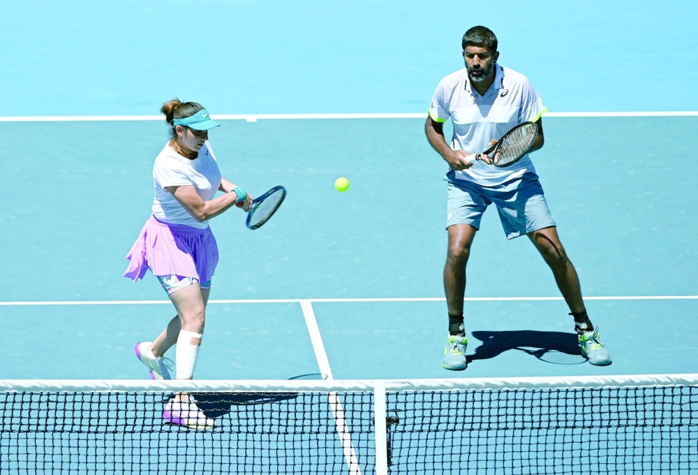 Tennis - Australian Open - Melbourne Park, Melbourne, Australia - January 27, 2023 India's Rohan Bopanna and Sania Mirza in action during their mixed doubles final against Brazil 's Luisa Stefani and Rafael Matos REUTERS/Jaimi Joy
