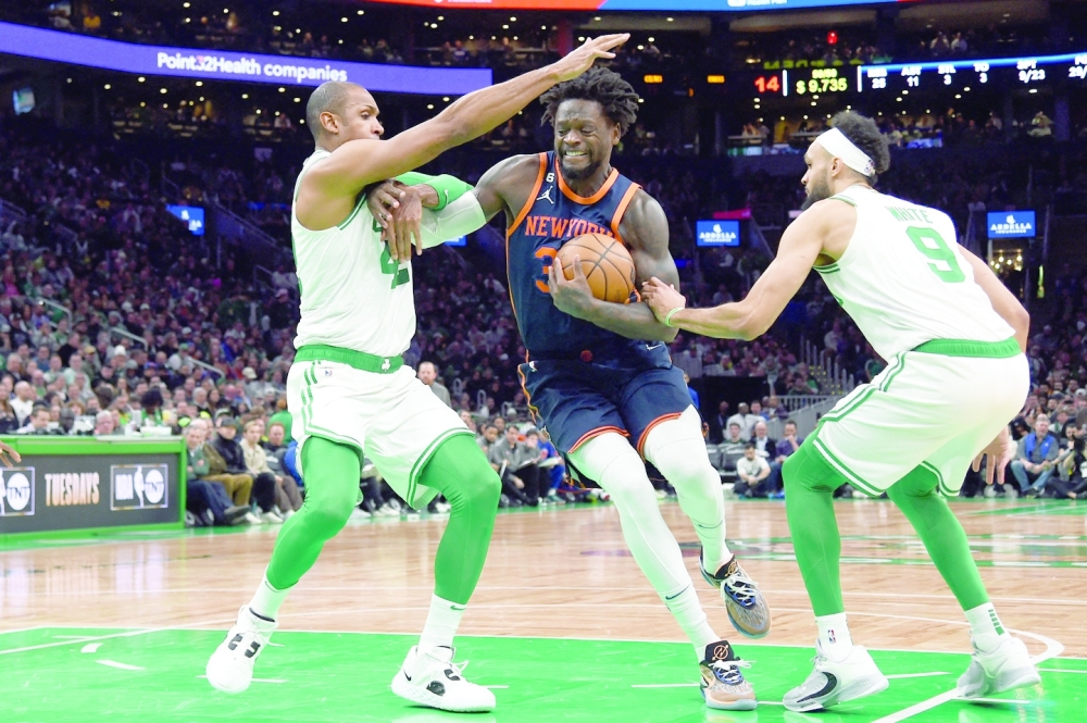 Jan 26, 2023; Boston, Massachusetts, USA; New York Knicks forward Julius Randle (30) drives to the basket between Boston Celtics center Al Horford (42) and guard Derrick White (9) during the second half at TD Garden. Mandatory Credit: Bob DeChiara-USA TODAY Sports
