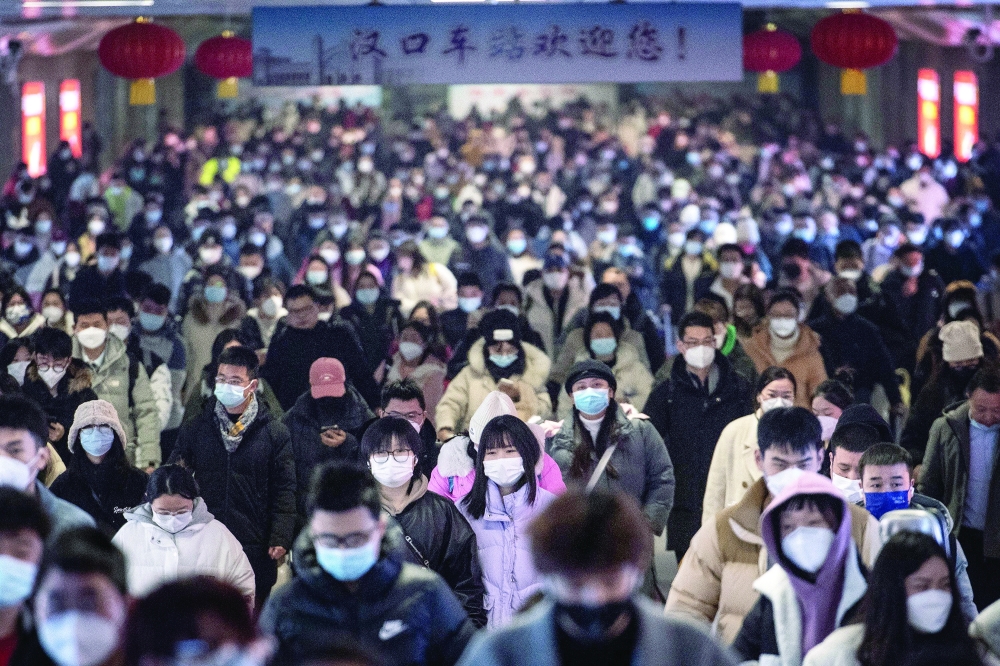 Passengers arriving at Hankou railway station on the last day of the Lunar New Year holidays in Wuhan, in China's central Hubei province, on Friday. - AFP