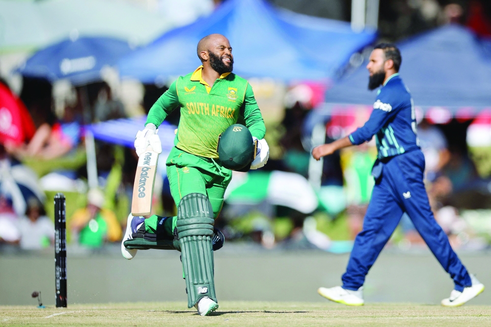 South Africa's Temba Bavuma runs in the pitch as he celebrates after scoring a century (100 runs) during the second one day international (ODI) cricket match between South Africa and England at Mangaung Oval in Bloemfontein on January 29, 2023. (Photo by Marco Longari / AFP)

