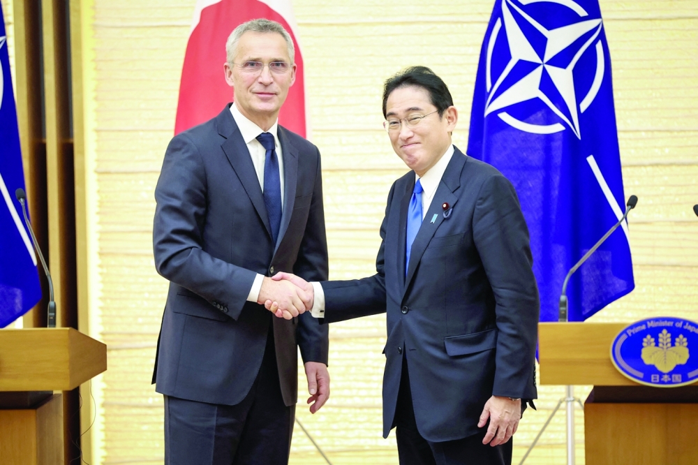 Nato Secretary-General Jens Stoltenberg (L) and Japan's Prime Minister Fumio Kishida shake hands after holding a joint media briefing in Tokyo on Tuesday. -- AFP