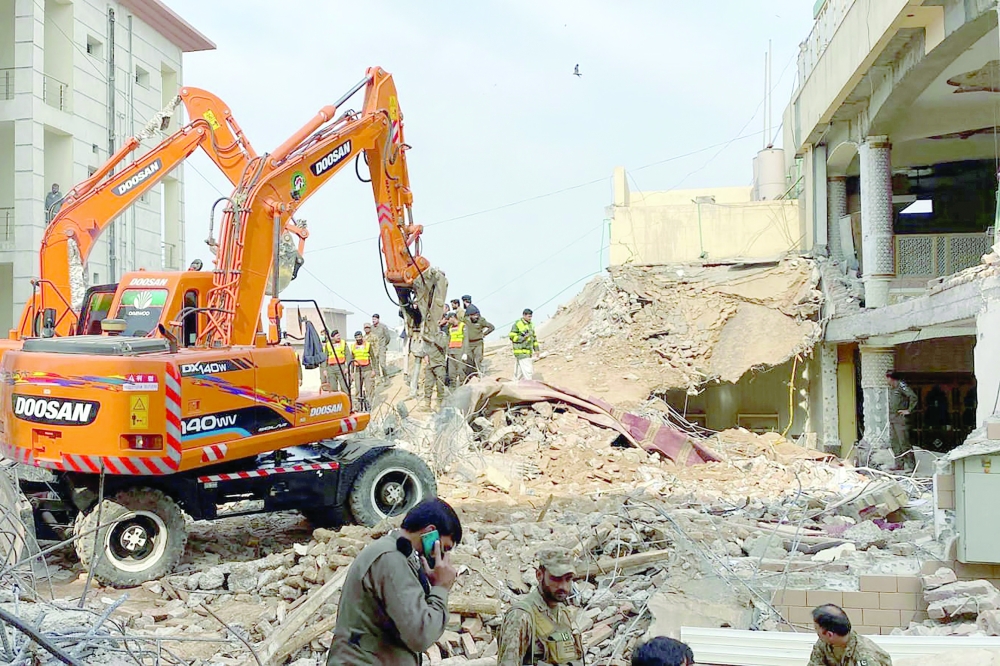 Authorities use heavy machinery to clear the rubble and search for victims a day after a suicide blast at a mosque inside the police headquarters in Peshawar on January 31, 2023.
 At least 95 people, mostly policemen, were killed in a suicide blast at a mosque inside a police headquarters in northwest Pakistan. (Photo by Maaz ALI / AFP)