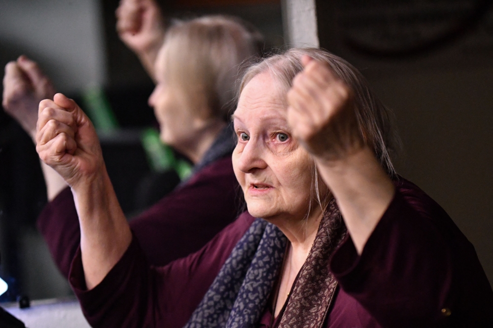 Yelena Osipova opens her exhibition of pacifist paintings in Saint Petersburg on Tuesday. The exhibition will run until February 24. - AFP