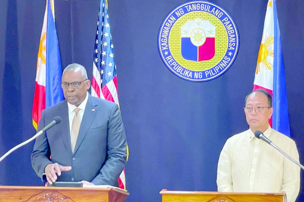 US Defence Secretary Lloyd Austin III talks beside his Philippine counterpart Carlito Galvez Jr at a joint press conference in Camp Aguinaldo military headquarters in metro Manila. - AFP