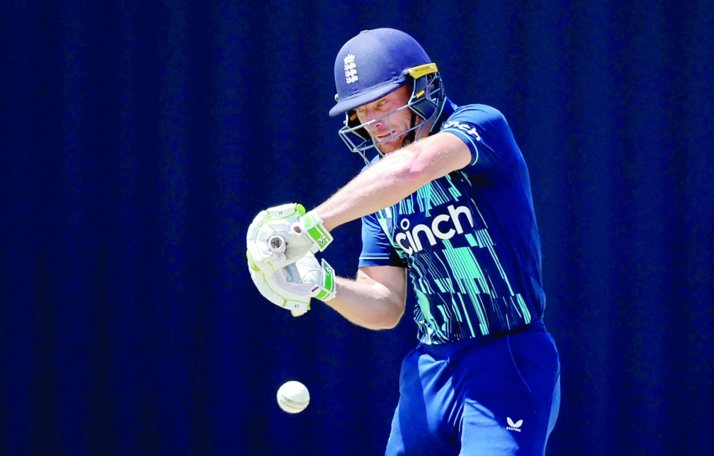 TOPSHOT - England's Captain Jos Buttler watches the ball as he plays a shot during the third one day international (ODI) cricket match between South Africa and England at Mangaung Oval in Kimberley on February 1, 2023. (Photo by Marco Longari / AFP)

