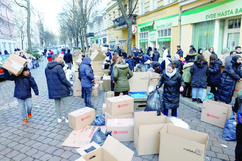 People work as members of a Turkish community in Berlin collect bags and boxes with warm clothes and other valuable goods to support victims of the deadly earthquake in Turkey, in a neighbourhood in Berlin. - Reuters

