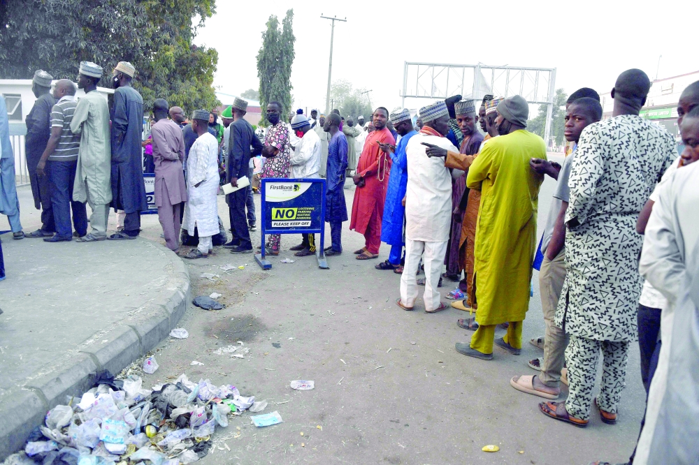 A plan to replace old Nigerian naira notes with new ones has caused a shortage of cash and long lines outside banks. -- AFP