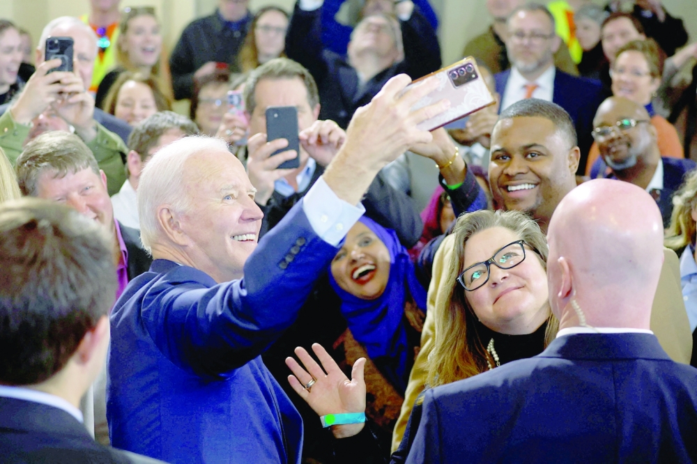 Joe Biden takes a selfie after delivering remarks on his economic priorities at a Laborers' International Union of North America training center in DeForest, Wisconsin. -- Reuters