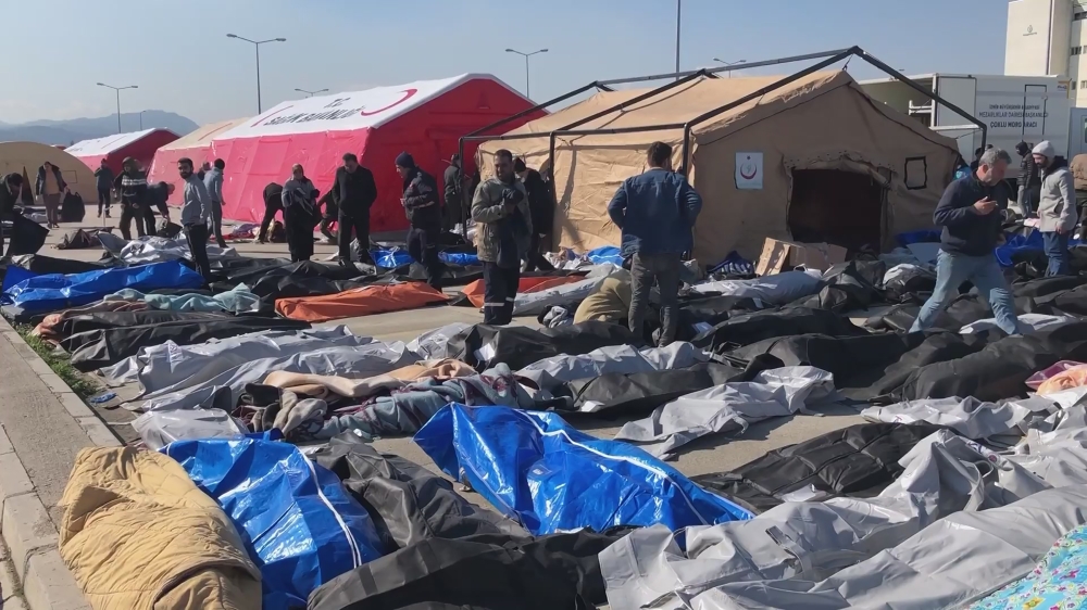 Hundreds of families search for deceased relatives at a makeshift morgue outside a hospital in Hatay Province, Turkey, in February 2023. (Tolga Ildun/The New York Times)