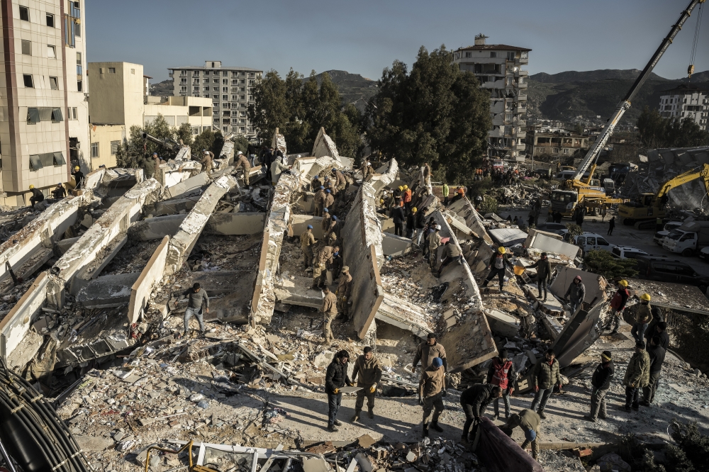 Turkish military personnel work to clear rubble from a collapsed residential building in Hatay, Turkey on Wednesday, Feb. 8, 2023. (Sergey Ponomarev/The New York Times)