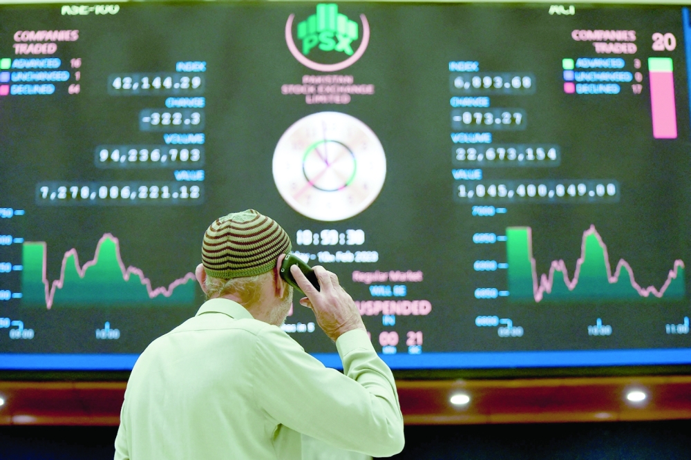 A broker talks on phone as he  looks an index board showing the latest share prices at the Pakistan Stock Exchange in Karachi. An IMF team left Pakistan on February 10 having failed to reach a deal on financial aid that would help the country avoid economic collapse. -- AFP