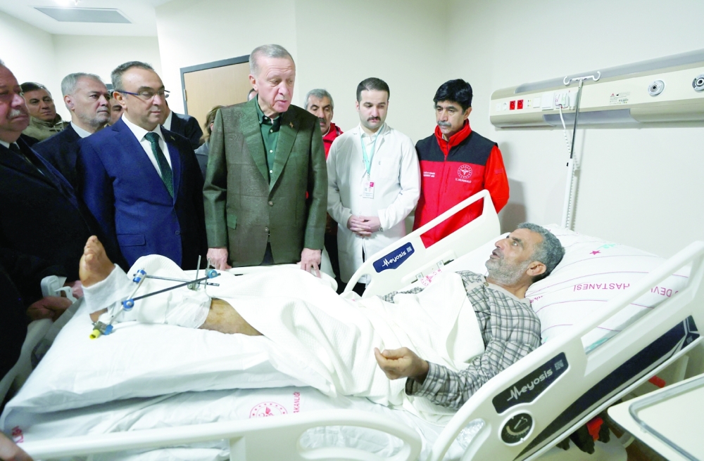 Turkish President Tayyip Erdogan visits a survivor at a hospital in Kilis, Turkey. — Reuters