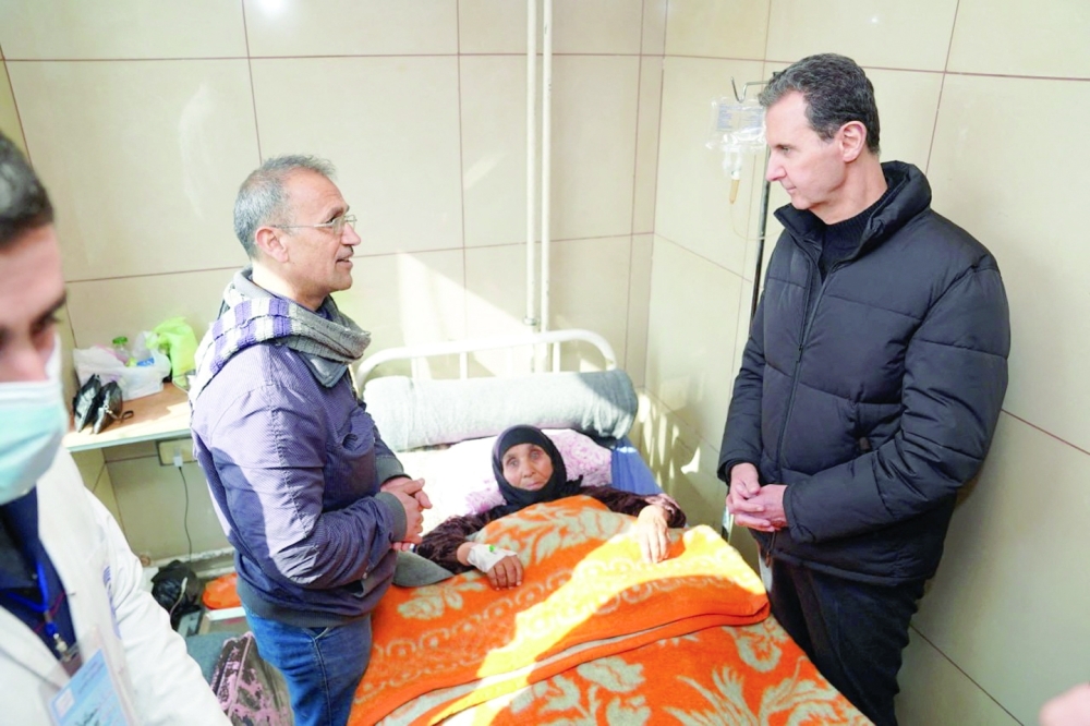 Syrian President Bashar al-Assad visits a woman at a hospital in Aleppo. — Reuters