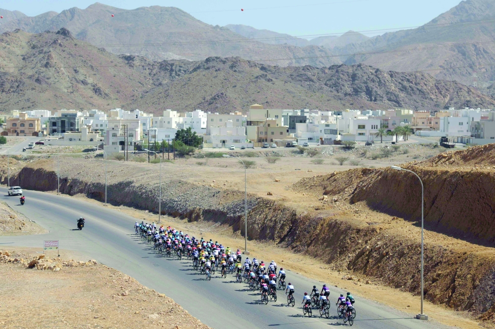 The pack rides during the first edition of the Muscat Classic on February 10, 2023.  (Photo by Thomas SAMSON / AFP)