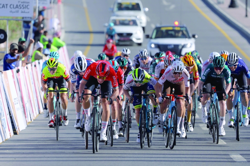 Team Arkea-Samsic Belgian rider Jenthe Biermans (C-L) rides to cross the finish line in the sprint race of the Muscat Classic on February 10, 2023.  (Photo by Thomas SAMSON / AFP)