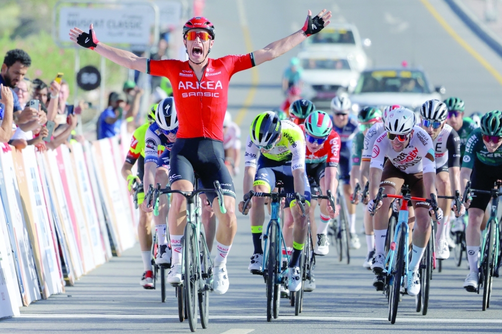 Team Arkea-Samsic Belgian rider Jenthe Biermans (L) celebrates after winning the sprint race of the Muscat Classic on February 10, 2023.  (Photo by Thomas SAMSON / AFP)