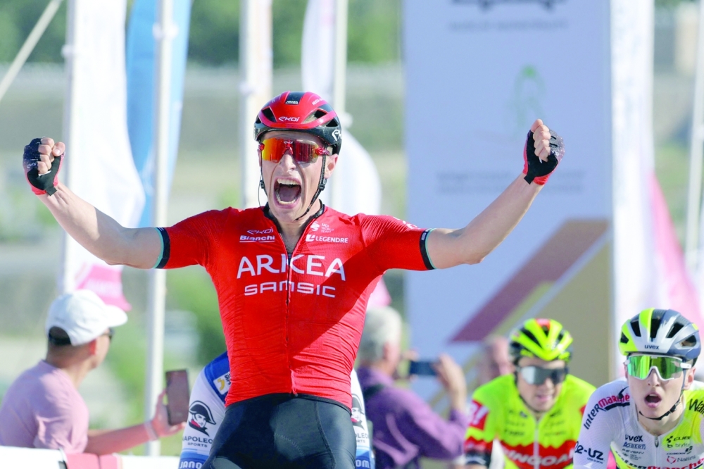 Team Arkea-Samsic Belgian rider Jenthe Biermans (L) celebrates after winning the sprint race of the Muscat Classic on February 10, 2023.  (Photo by Thomas SAMSON / AFP)