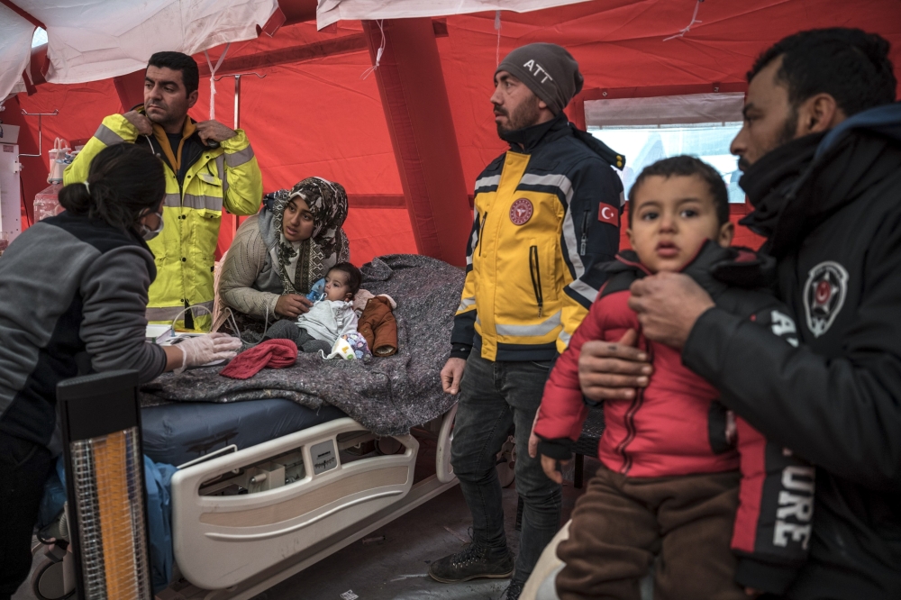 A child receives treatment at a field hospital in Antakya, in the hard-hit Hatay province of Turkey, on Friday, Feb. 10, 2023. (Sergey Ponomarev/The New York Times)