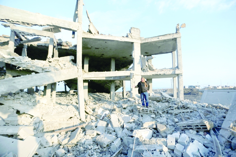A man inspects a wedding hall hit in Israeli air strikes but the Israeli military described as an underground Hamas rocket foundry in Gaza City. - Reuters
